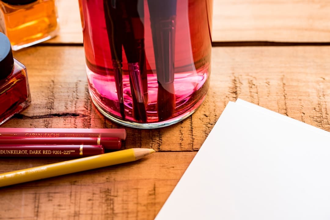 A sheet of printed paper and a pen resting on a wooden desk in soft daylight