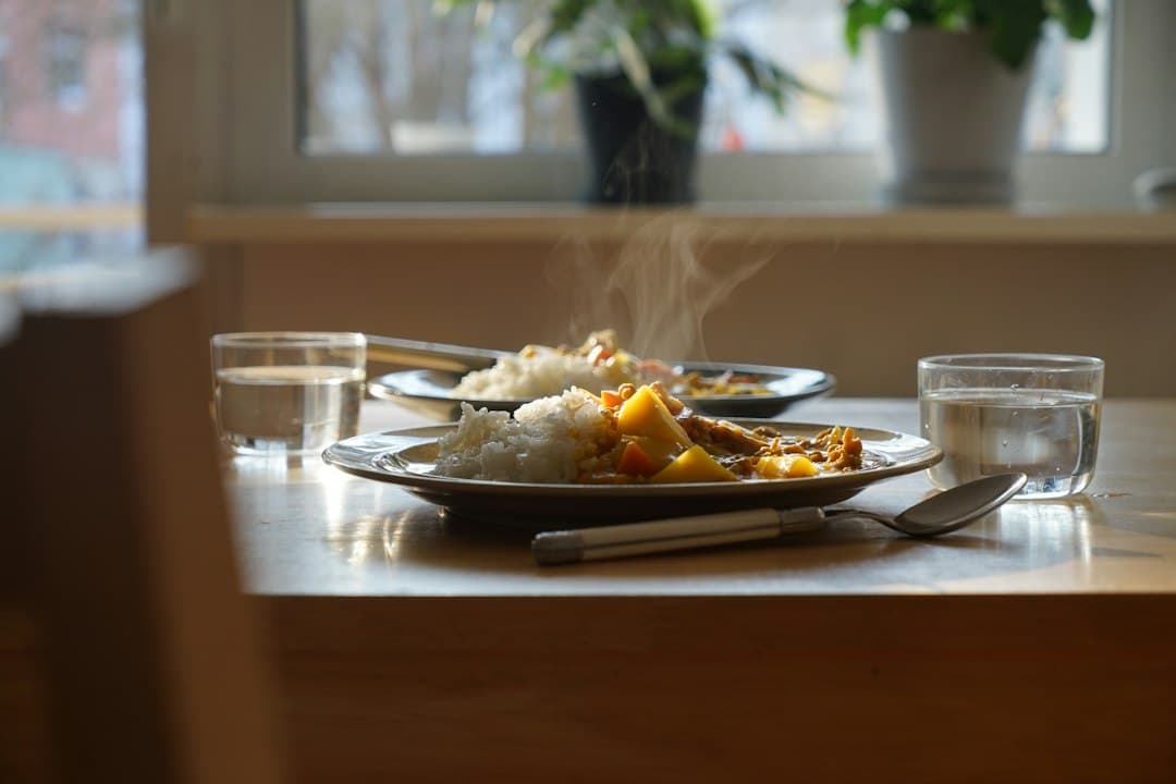 A simple plate of food on a warm wooden table in soft daylight
