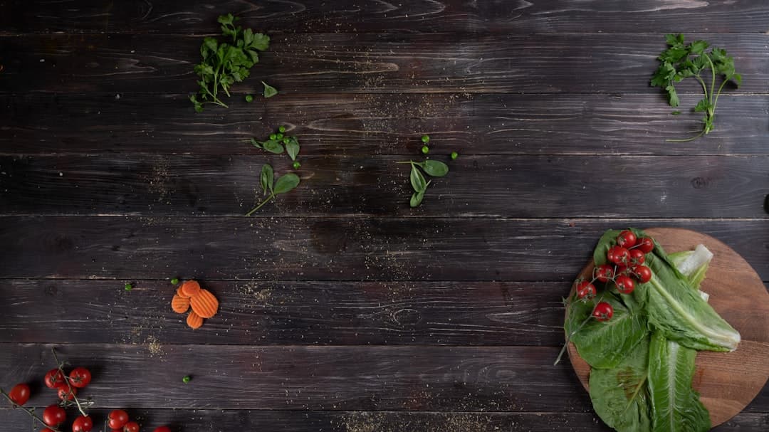 Fresh vegetables on a cutting board on a wooden kitchen counter in soft daylight