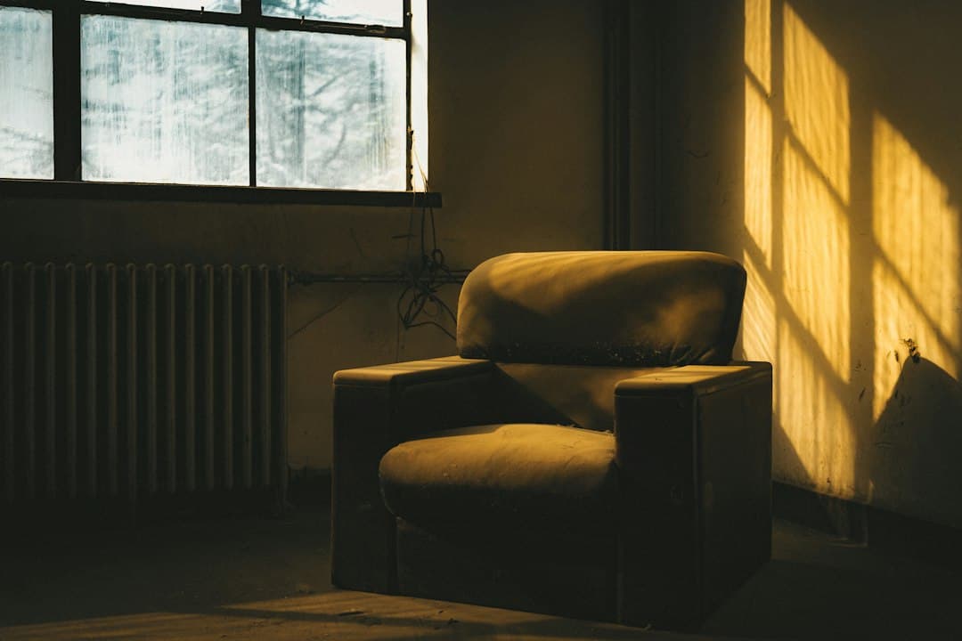 An armchair beside a window in warm afternoon sunlight