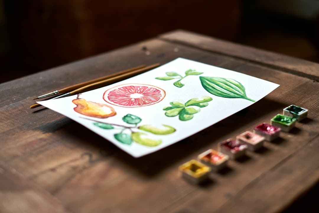 Watercolor illustrations of a variety of fruits laid out on a table