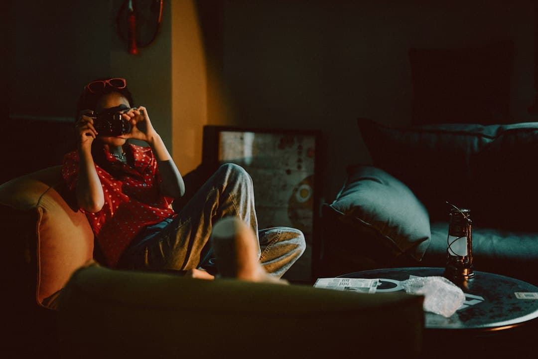A person resting on a couch in warm sunlight