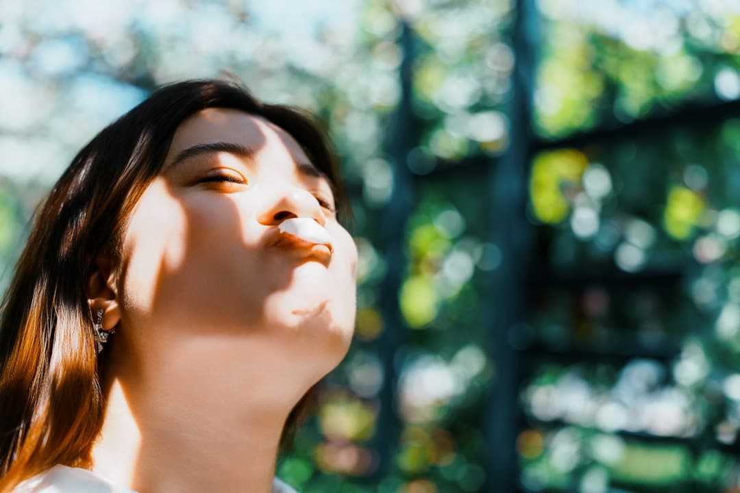 A woman with her eyes closed and sunlight on her face